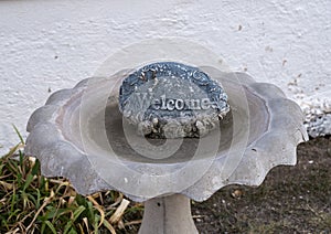 Bird bath with engraved Welcomed stone at the historic Saint Joseph Catholic Church in Fort Davis, Texas.