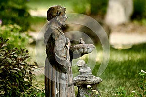 Garden Setting with a Statue and Fountain