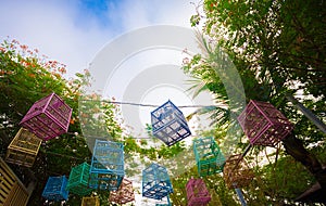 Bird cage hanging outdoors Lots bright colors