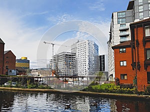 A bird in the canal in front of construction ( Birmingham / UK