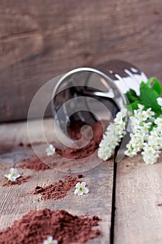 Bird cherry flour with sifter on wooden table