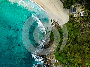 Bird eye view seashore with big wave crashing on rock cliff. Beautiful waves sea surface in sunny day summer background, Amazing