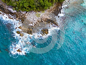 Bird eye view seashore with big wave crashing on rock cliff. Beautiful waves sea surface in sunny day summer background, Amazing