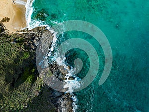 Bird eye view seashore with big wave crashing on rock cliff. Beautiful waves sea surface in sunny day summer background, Amazing