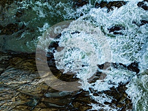 Bird eye view seashore with big wave crashing on rock cliff. Beautiful waves sea surface in sunny day summer background, Amazing