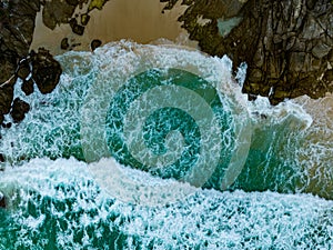 Bird eye view seashore with big wave crashing on rock cliff. Beautiful waves sea surface in sunny day summer background, Amazing