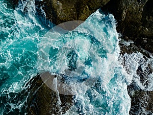 Bird eye view seashore with big wave crashing on rock cliff. Beautiful waves sea surface in sunny day summer background, Amazing