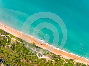 Bird eye view seashore with wave crashing on sandy shore. Beautiful waves sea surface in sunny day summer background, Amazing