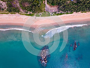 Bird eye view seashore with wave crashing on sandy shore. Beautiful waves sea surface in sunny day summer background, Amazing