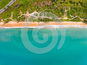 Bird eye view seashore with wave crashing on sandy shore. Beautiful waves sea surface in sunny day summer background, Amazing