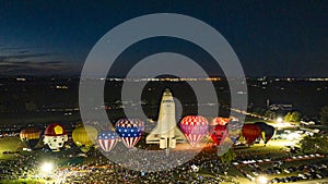 Aerial View of Hot Air Balloons Doing a Balloon Glow With a Space Shuttle at Night on a Summer Nite