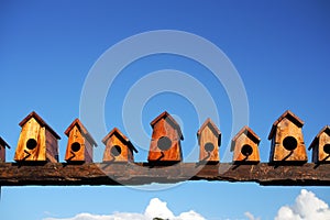 Bird house nesting on blue sky background