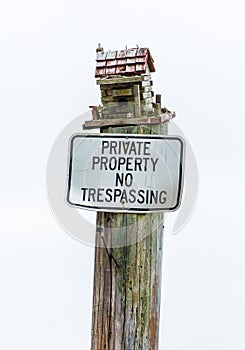 Bird House on Post with Private Property No Trespassing Sign