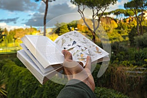 Bird Identification field guide in hand walking