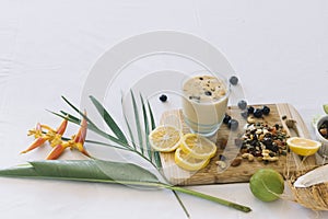 bird paradise flower smoothie with dryfruits citrus fruits white background. High quality photo