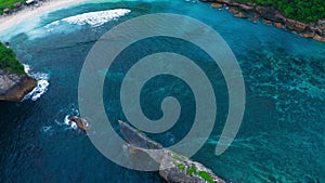 Bird's-eye view of beautiful bay of Atun beach with rocks on island of Nusa Penida. Beautiful tropical island beach