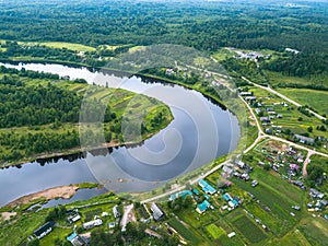 Bird`s-eye view of the bend of the river and the village Vazhinka Kurapovo village, Leningrad region.
