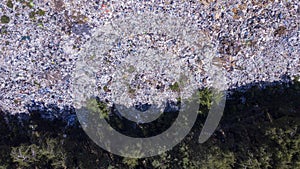 Bird`s eye view of ecological disaster, garbage dump on the border with forest