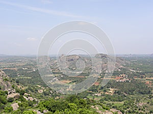 Bird`s eye view of landscape of green trees, fields and forest from top of mountain