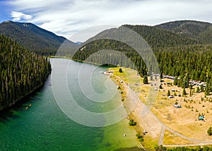 Bird`s eye view photo of Lightning Lake in E. C. Manning Provincial Park while people are enjoying outdoor activities at the lake