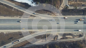 Bird's-eye view of the roundabout, cars moving fast along the road.