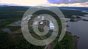 Bird`s-eye view of the Russian tank farm on the White Sea. The span of the drone over the taiga to the tank farm.