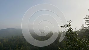 Bird`s-eye view of a scenic sunset over the forest hills. Summer mountain landscape. Tourist tents near forest