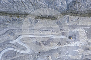 Bird`s eye view to stone pit quarry with shovel excavator