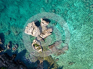 A bird's-eye view from top to bottom of the seashore. Clear azure water and rocks on the beach. Antalya, Turkey