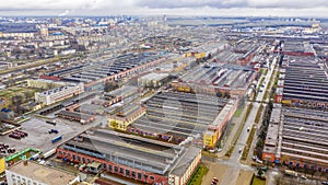 A bird`s-eye view of a warehouse, industrial plant, or logistics center from above. Top view of industrial buildings, equipment an