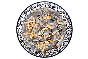 Bird seeds. Close-up of a decorative bowl with black sunflower seeds and other seed and nuts for feeding wild birds. Animal