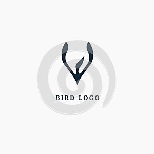 Bird silhouette logo. Vector abstract minimalistic illustration flying fowl. Pigeon icon. Zoo, pet shop, farm, bird feather, wild photo
