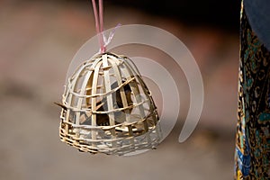 Bird slave in bamboo cage