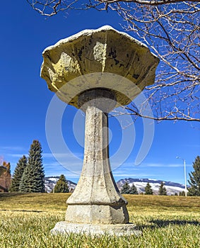 Birdbath in foreground shows Cody, Wyoming, mountain pass to Yellowstone National Park in the distance