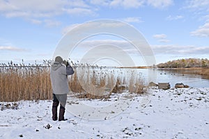 Birder by a bay in winter season photo