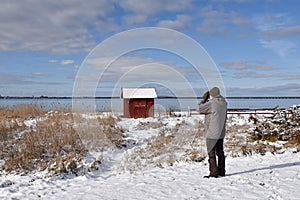 Birder by the coast in winter season photo