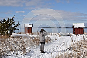 Birder watching by the coast in winter season