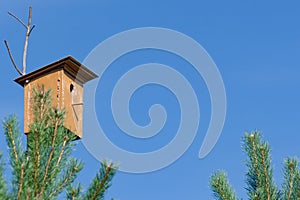 Birdhouse on background of a blue sky.