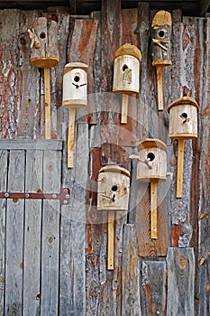 Birdhouses on the wooden wall of barn