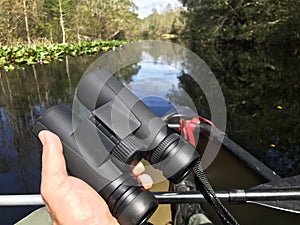 Birding with binoculars from a canoe in Okefenokee Swamp Georgia photo