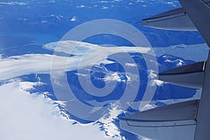 Birds eye view of Glacier under the plane wing