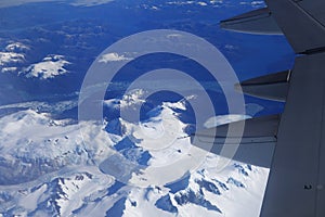 Birds eye view of Glacier under the plane wing