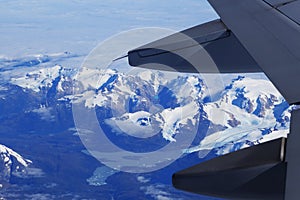 Birds eye view of Glacier under the plane wing