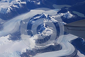 Birds eye view of Glacier under the plane wing