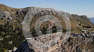 Birds eye view of Mirador Es Colomer viewpoint from the sea. Tourists on an excursion at scenic and very popular tourist place