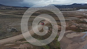 Birds eye view off road jeep driving in wild landscape, Iceland. Aerial view 4x4 vehicle speeding traveling across mossy