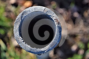 Birds eye view from a round steel pipe end in a field