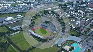 Birds eye view of sport complex in Reykjavik suburbs, Iceland, with swimming pool and football fields. Aerial view of