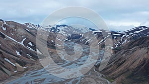 Birds eye view of the valley of Thorsmork with glacier river and snowy highlands in Iceland. From above view of Krossa