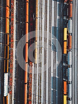 Birds eye view, vertical photo directly above cargo trains parked at the train station